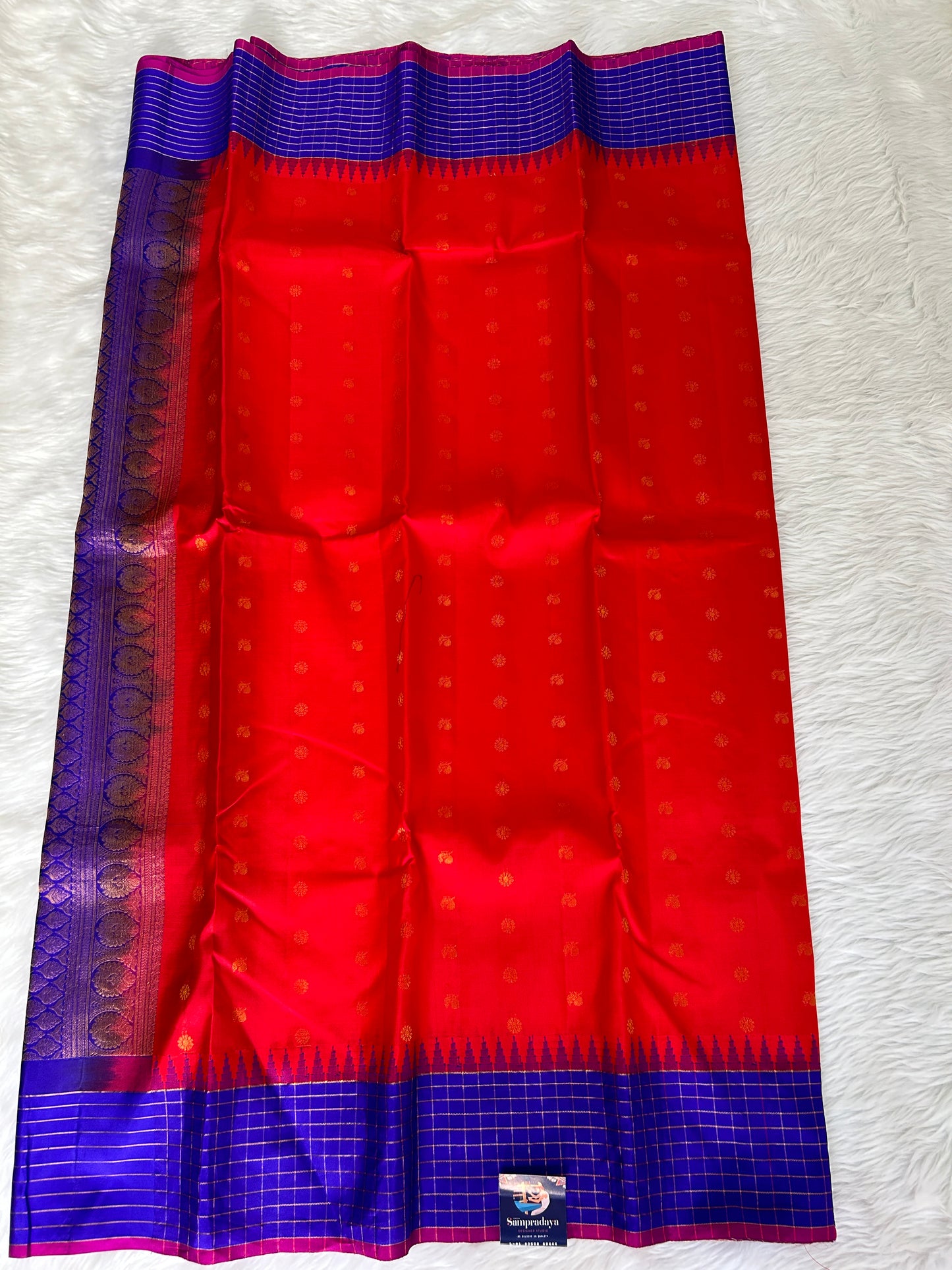 Gadwal Pattu Saree Blood Red-colored saree complemented with a Navy Blue border - Sampradaya Designer Studio