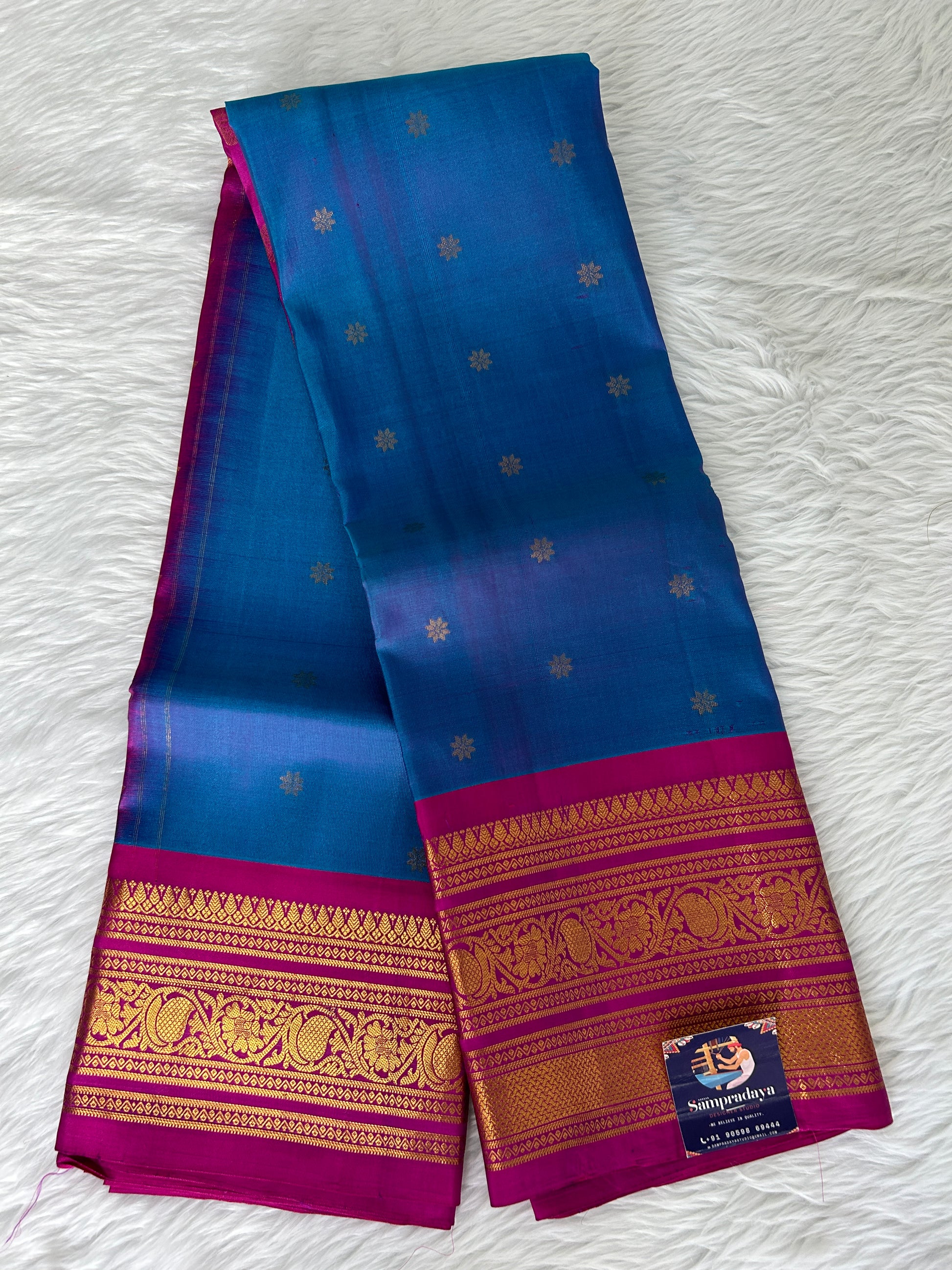Gadwal Pattu Saree Deep Sea Blue-colored saree complemented with a magenta pink border - Sampradaya Designer Studio