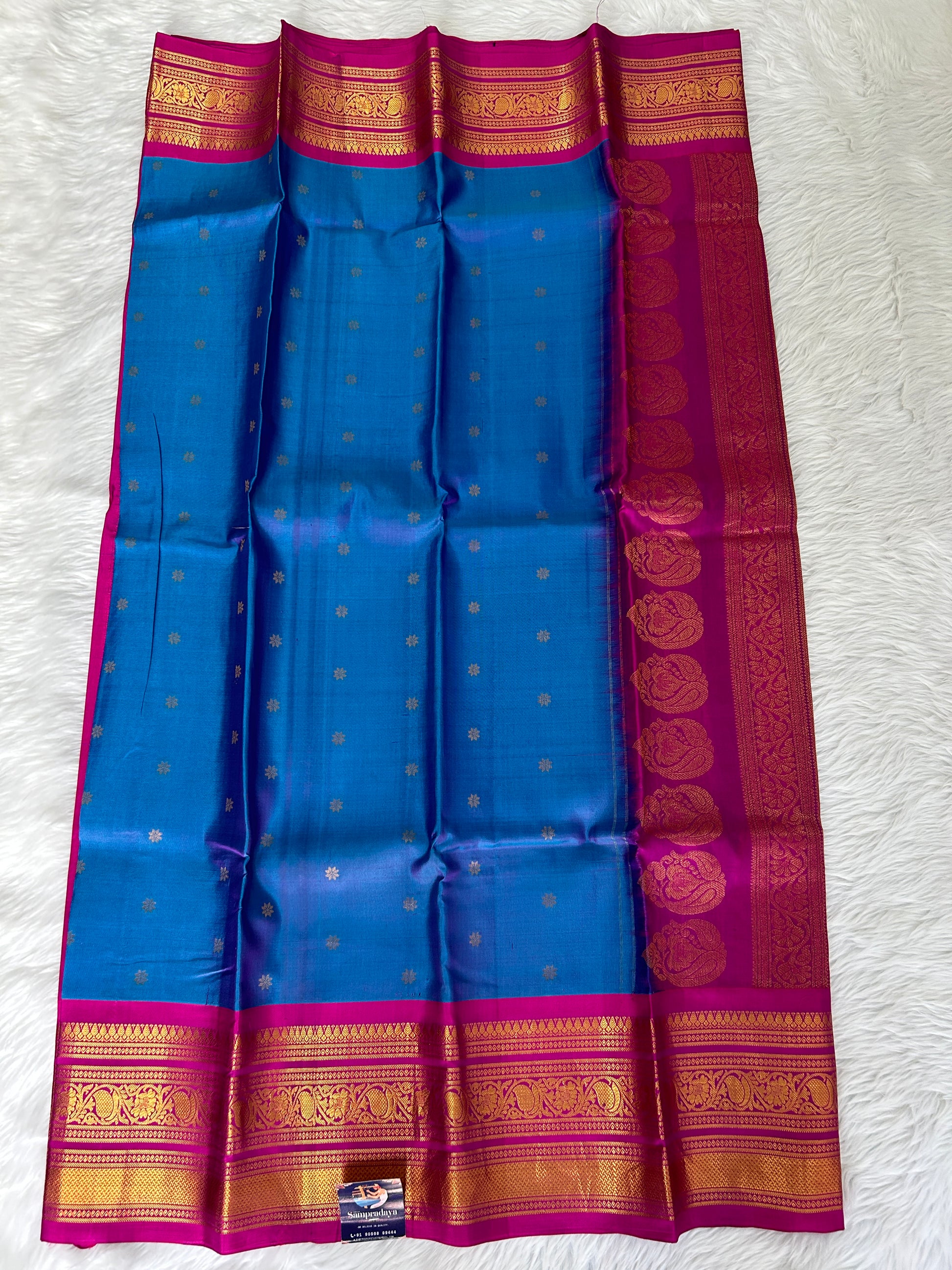 Gadwal Pattu Saree Deep Sea Blue-colored saree complemented with a magenta pink border - Sampradaya Designer Studio