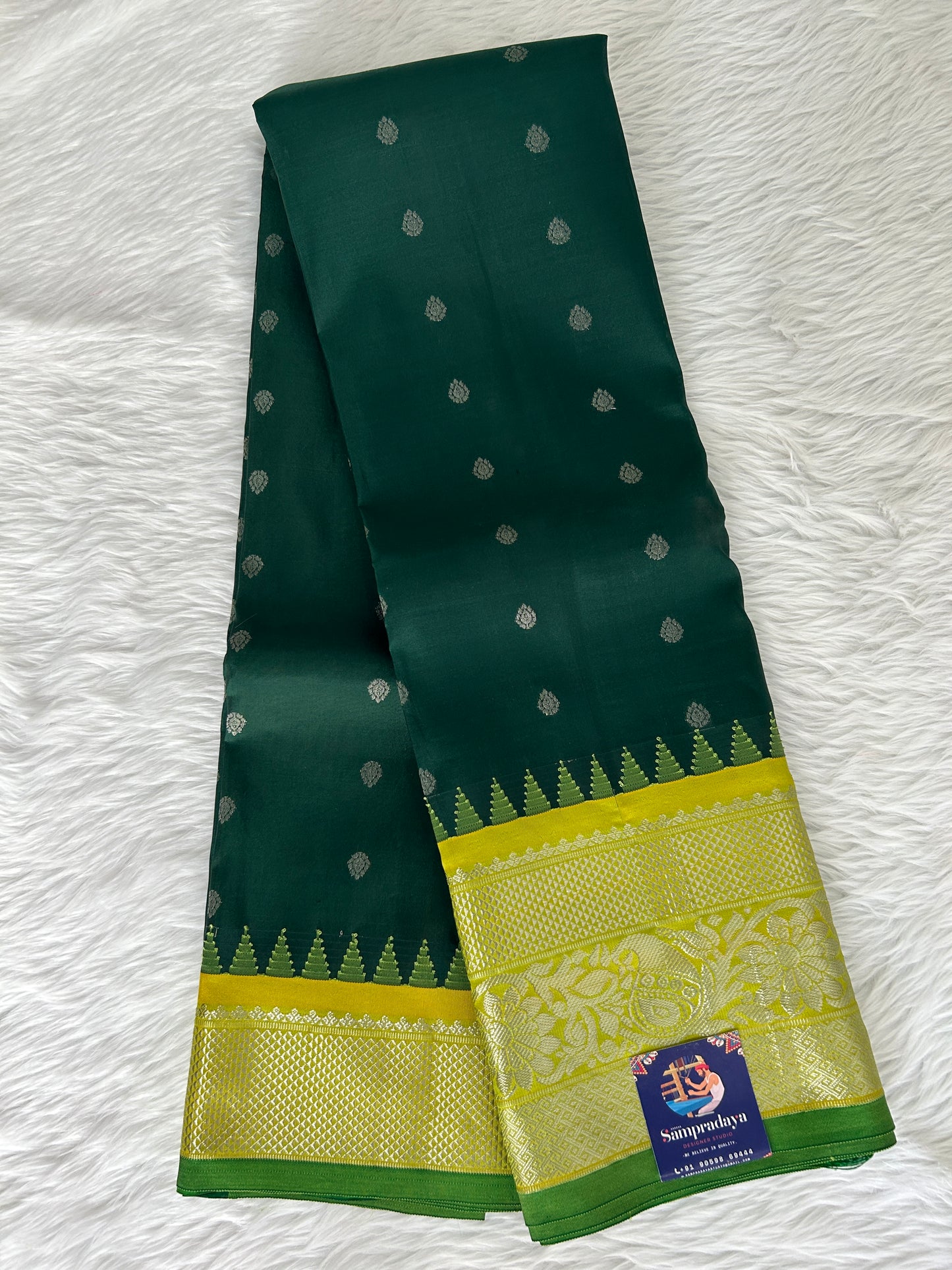 Gadwal Pattu Saree Bottle Green-colored saree complemented with a Lemon Yellow border - Sampradaya Designer Studio