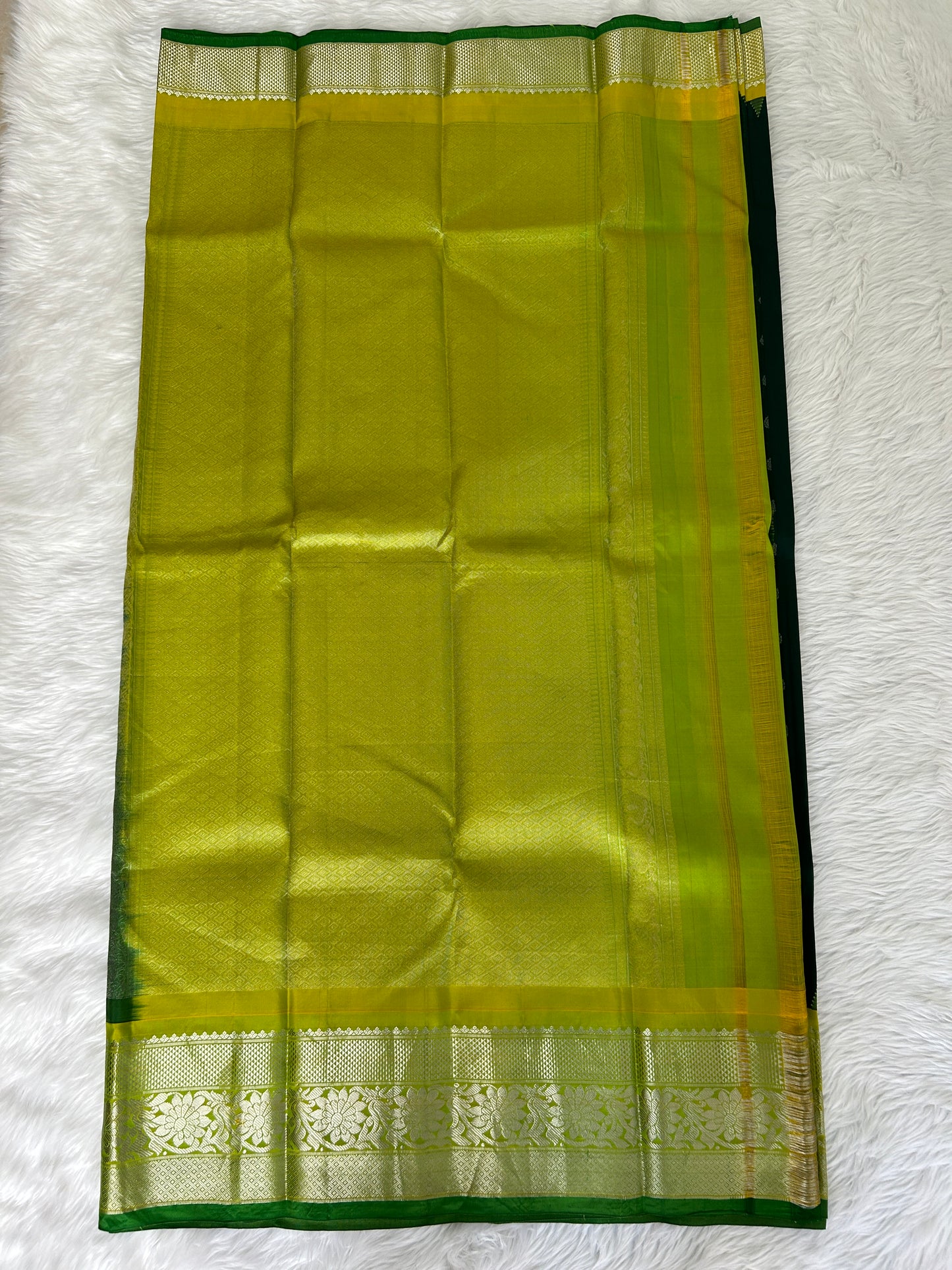 Gadwal Pattu Saree Bottle Green-colored saree complemented with a Lemon Yellow border - Sampradaya Designer Studio