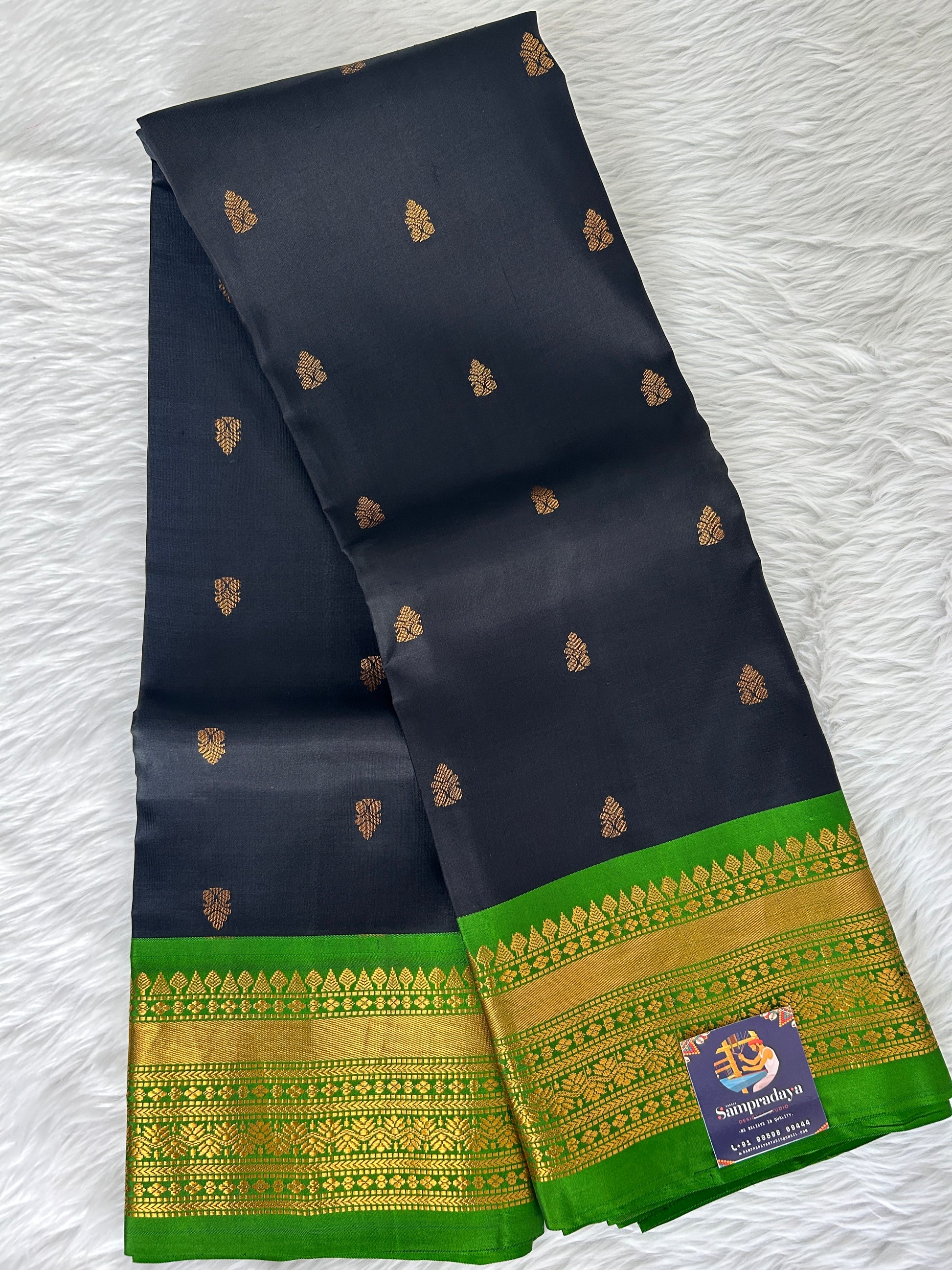 Gadwal Pattu Saree Black colored saree complemented with a Parrot Green Kanchi border - Sampradaya Designer Studio