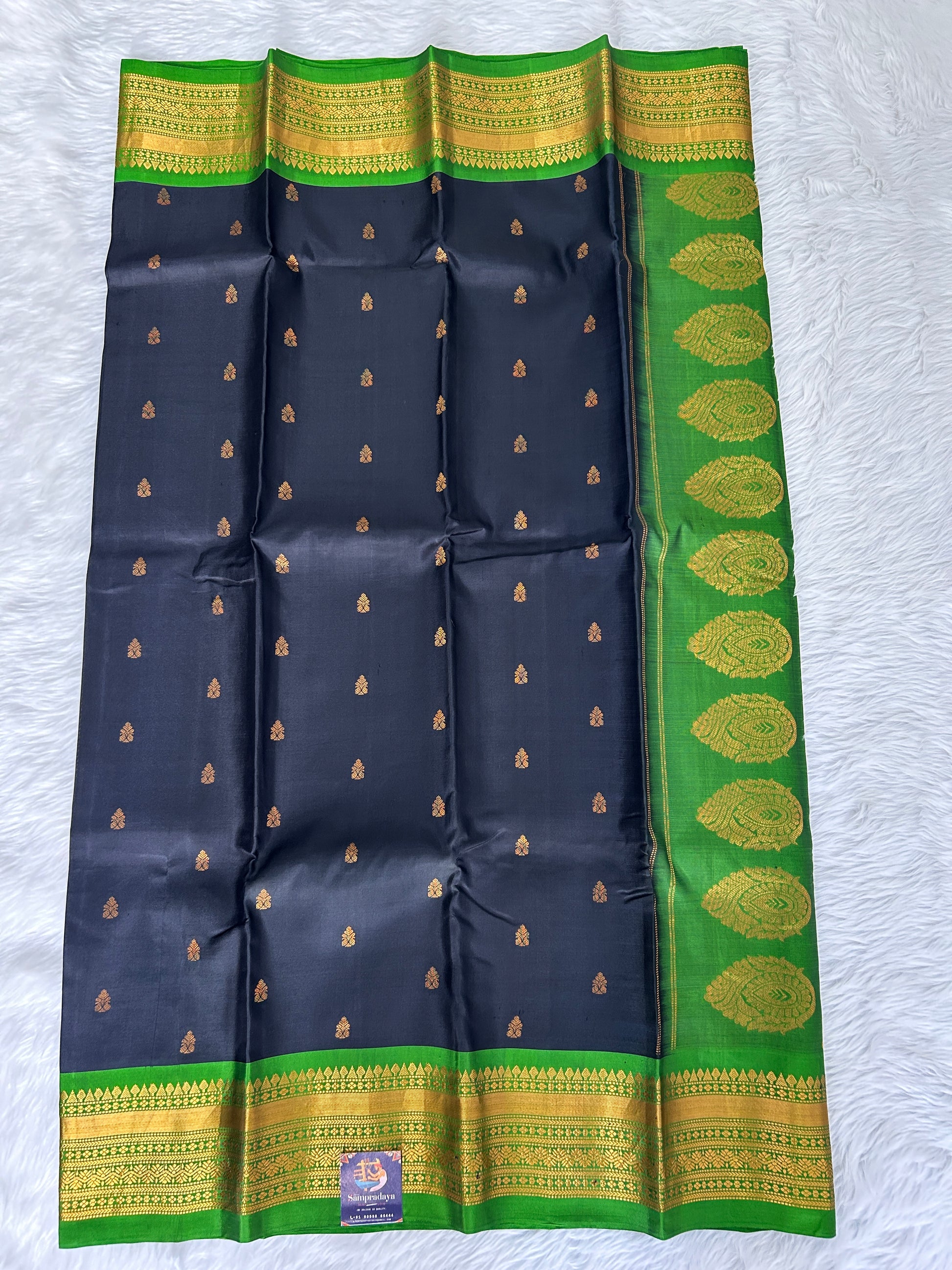 Gadwal Pattu Saree Black colored saree complemented with a Parrot Green Kanchi border - Sampradaya Designer Studio