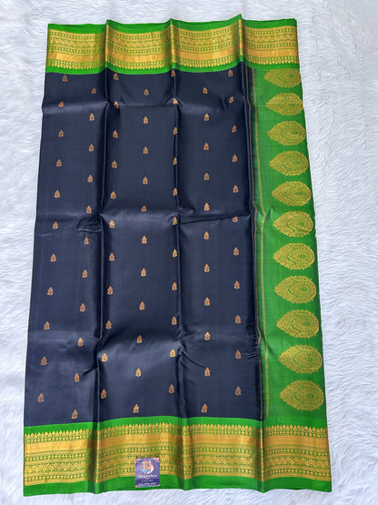 Gadwal Pattu Saree Black colored saree complemented with a Parrot Green Kanchi border - Sampradaya Designer Studio