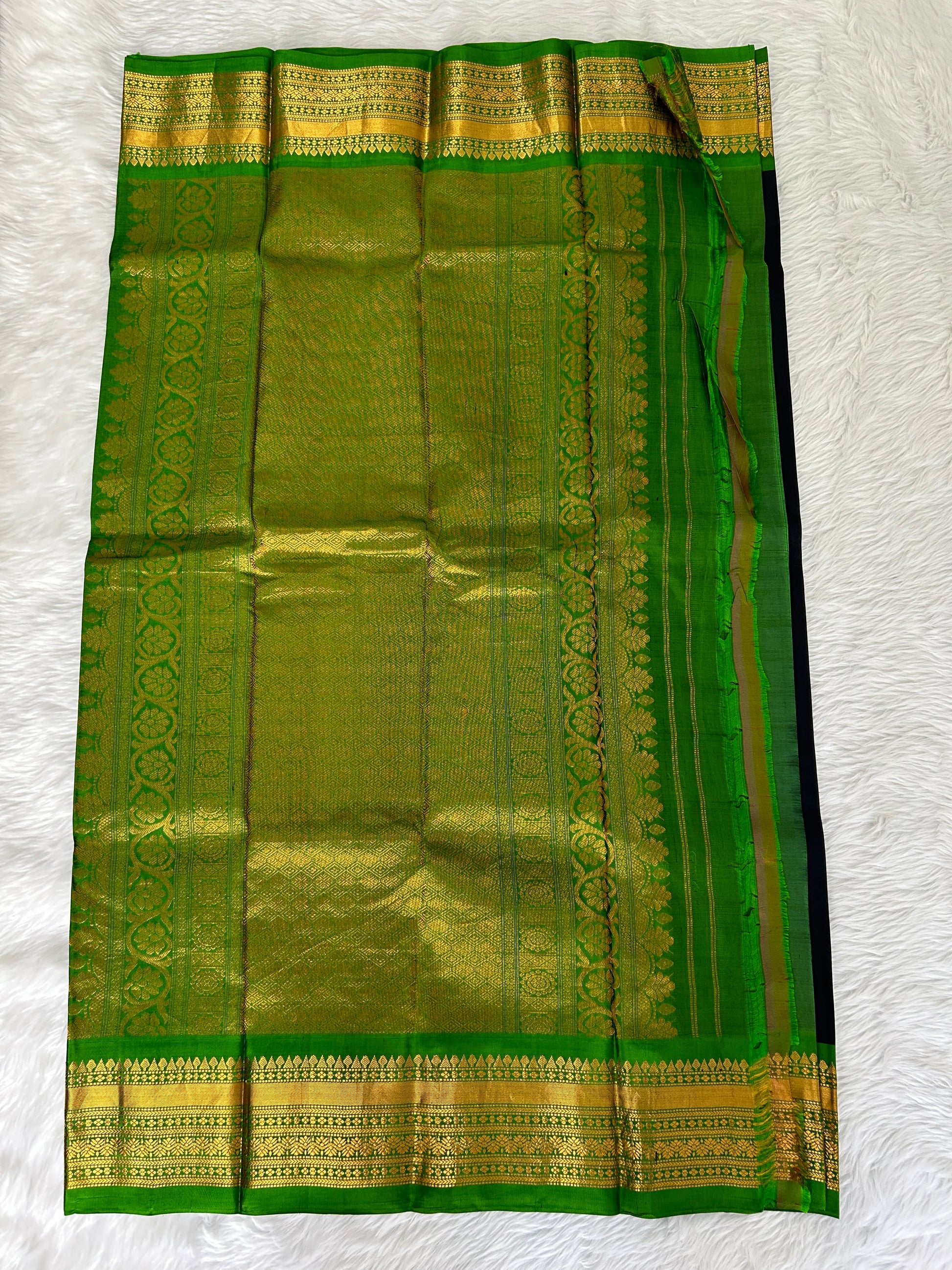 Gadwal Pattu Saree Black colored saree complemented with a Parrot Green Kanchi border - Sampradaya Designer Studio