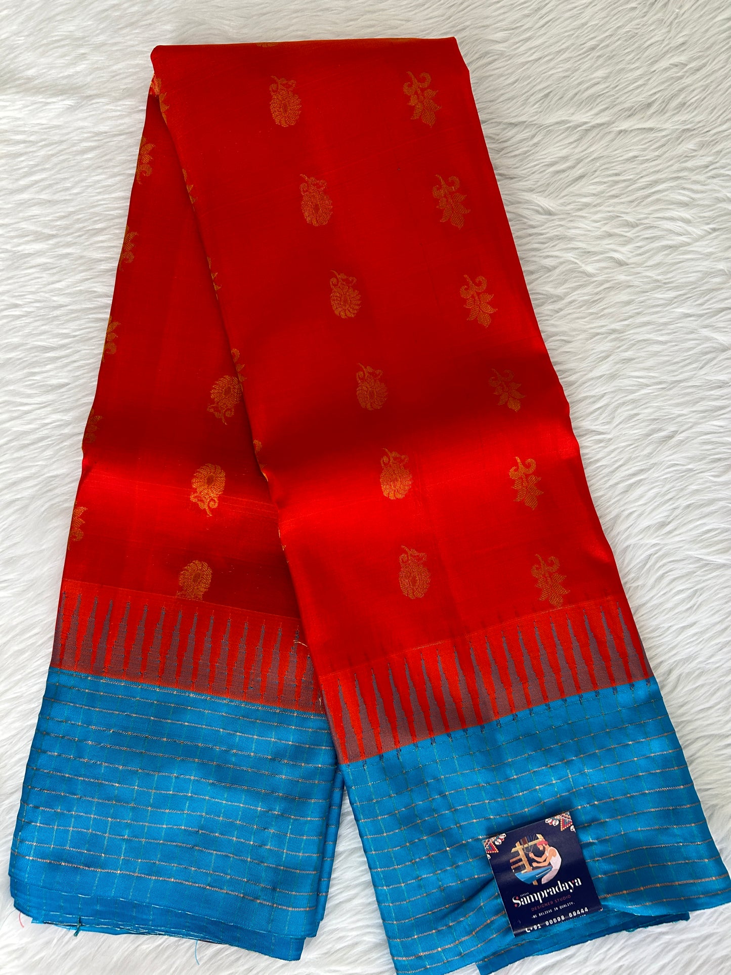 Gadwal Pattu Saree Red-colored saree complemented with a Blue border - Sampradaya Designer Studio