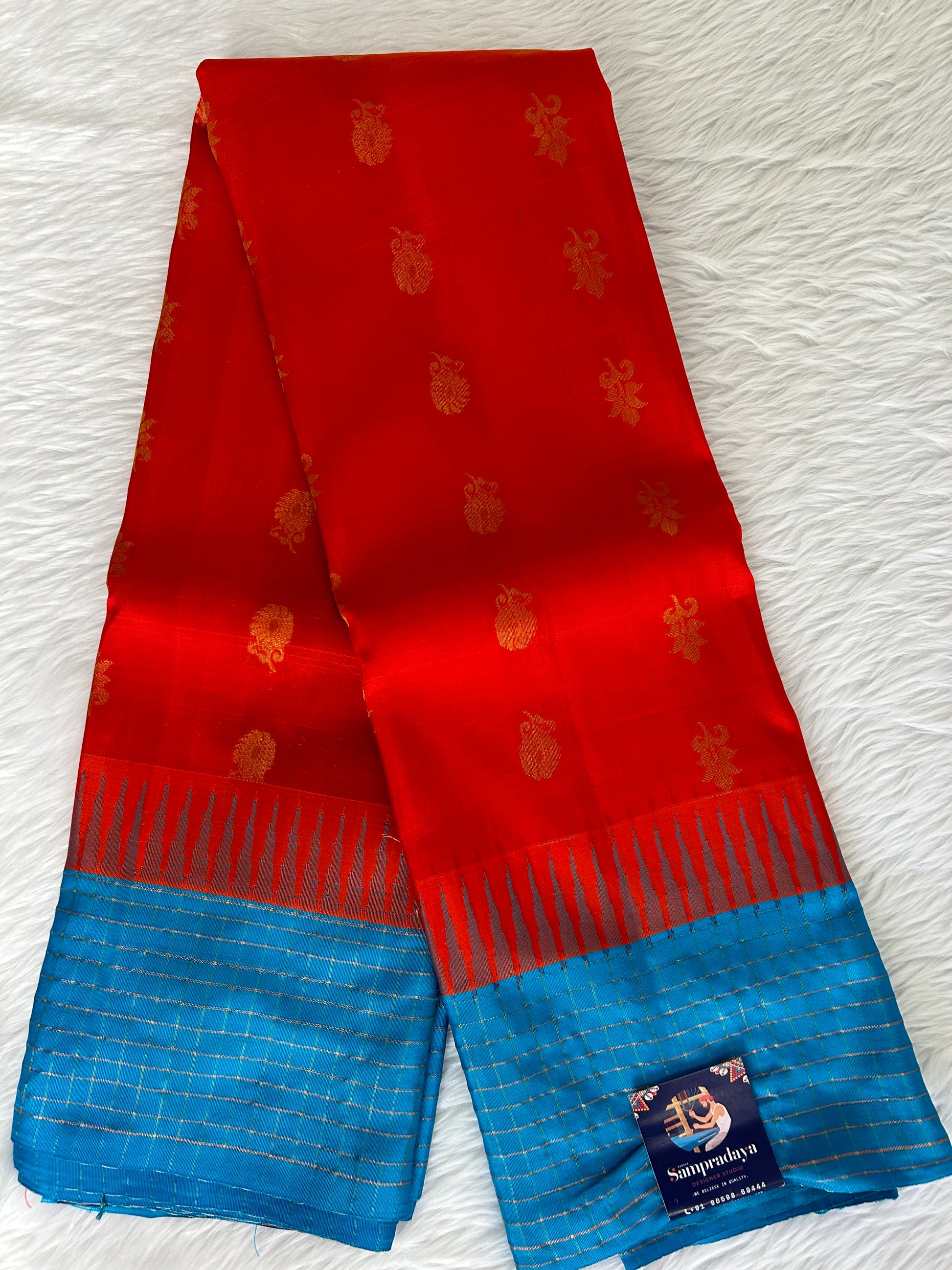 Gadwal Pattu Saree Red-colored saree complemented with a Blue border - Sampradaya Designer Studio