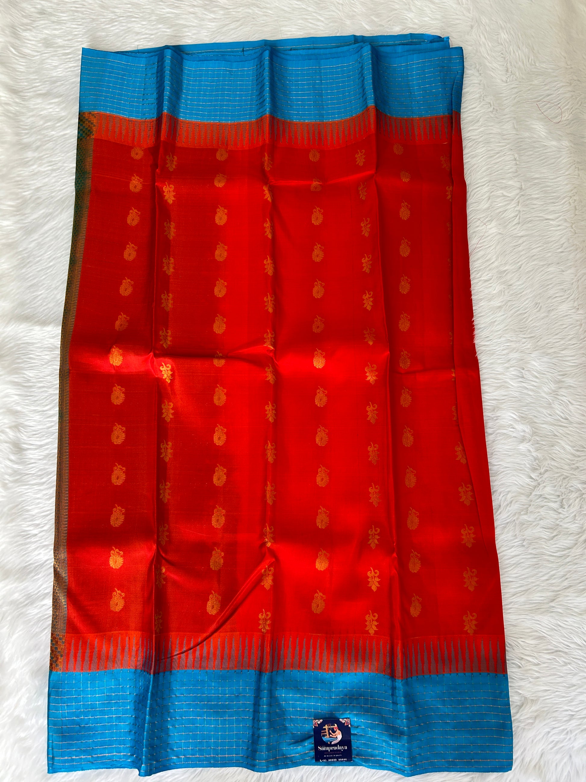 Gadwal Pattu Saree Red-colored saree complemented with a Blue border - Sampradaya Designer Studio