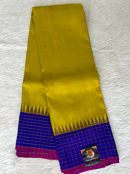 Gadwal Pattu Saree Lemon Yellow colored saree complemented with a Royal Blue border - Sampradaya Designer Studio