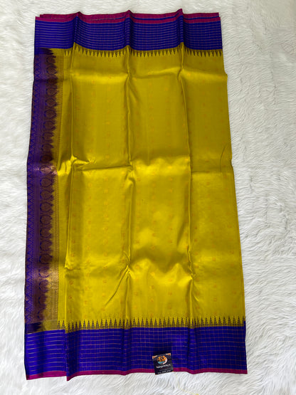 Gadwal Pattu Saree Lemon Yellow colored saree complemented with a Royal Blue border - Sampradaya Designer Studio