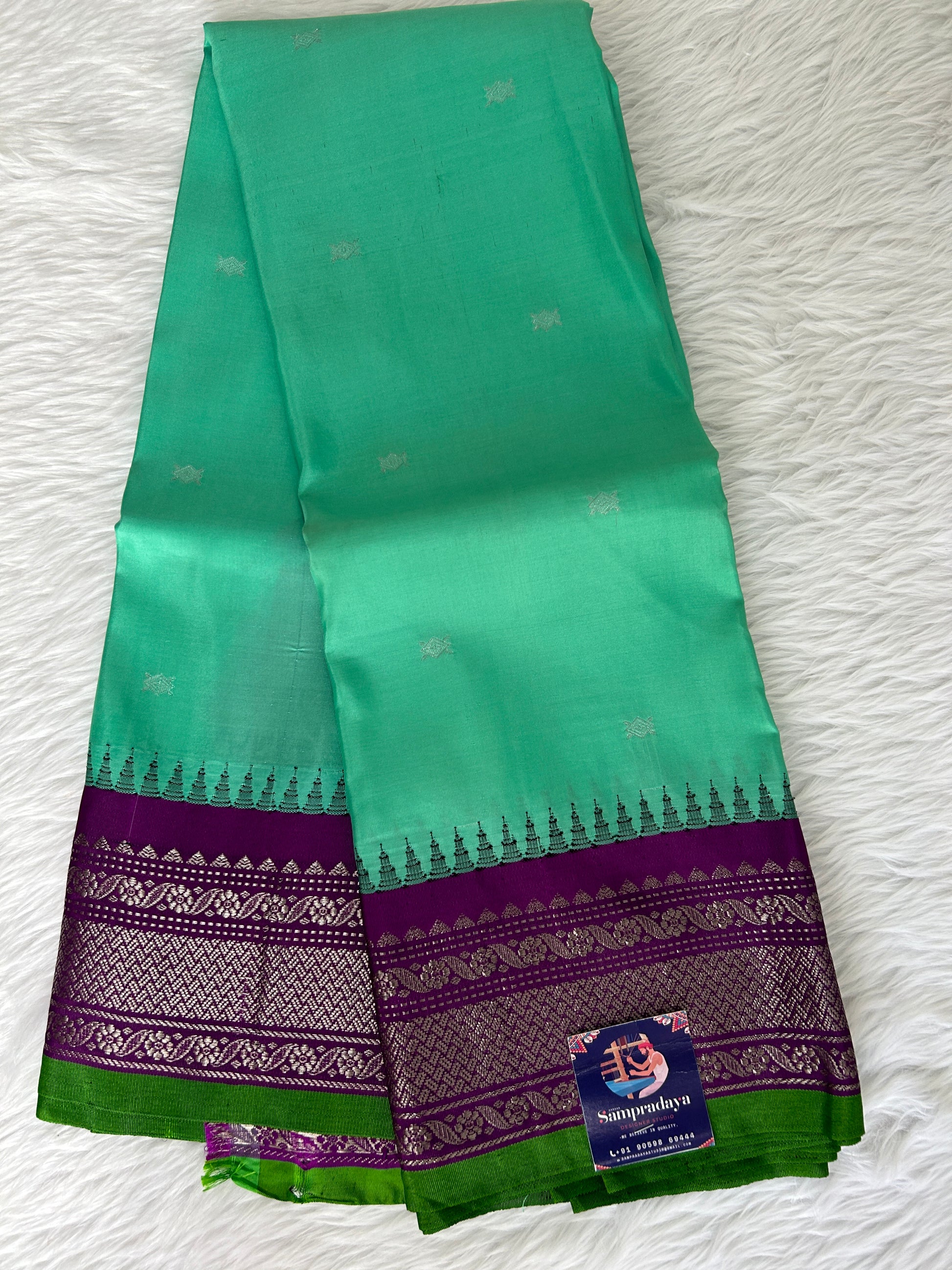 Gadwal Pattu Saree Greenish Cyan colored saree complemented with a Purple Kanchi border - Sampradaya Designer Studio