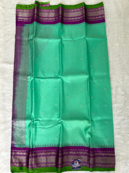 Gadwal Pattu Saree Greenish Cyan colored saree complemented with a Purple Kanchi border - Sampradaya Designer Studio