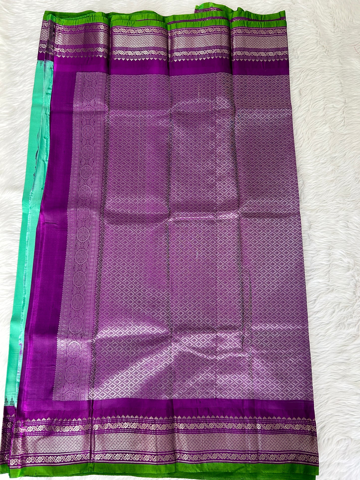Gadwal Pattu Saree Greenish Cyan colored saree complemented with a Purple Kanchi border - Sampradaya Designer Studio