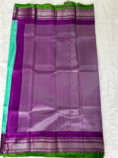 Gadwal Pattu Saree Greenish Cyan colored saree complemented with a Purple Kanchi border - Sampradaya Designer Studio