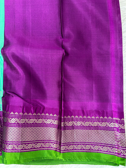 Gadwal Pattu Saree Greenish Cyan colored saree complemented with a Purple Kanchi border - Sampradaya Designer Studio