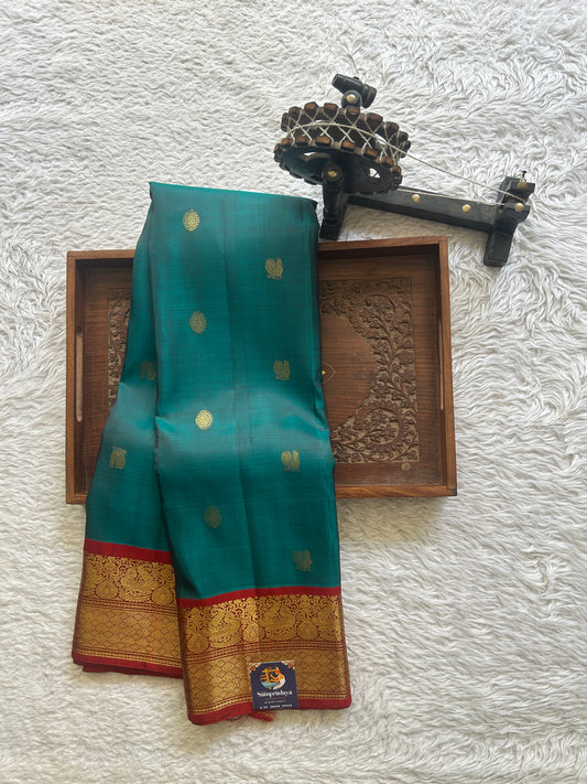 Pure Kanjivaram Silk Saree Peacock Blue Colored Complemented with Red Color Border a Gold Zari Weaving. - Sampradaya Designer Studio