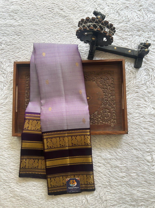 Pure Kanjivaram Silk Saree Lilac Colored Complemented with Purple Color Gap Border with a Gold Zari Weaving. - Sampradaya Designer Studio