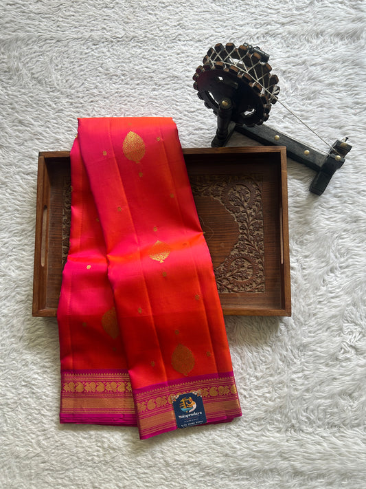 Pure Kanjivaram Silk Saree Orange Colored Complemented with Pink Color Border a Gold Zari Weaving. - Sampradaya Designer Studio