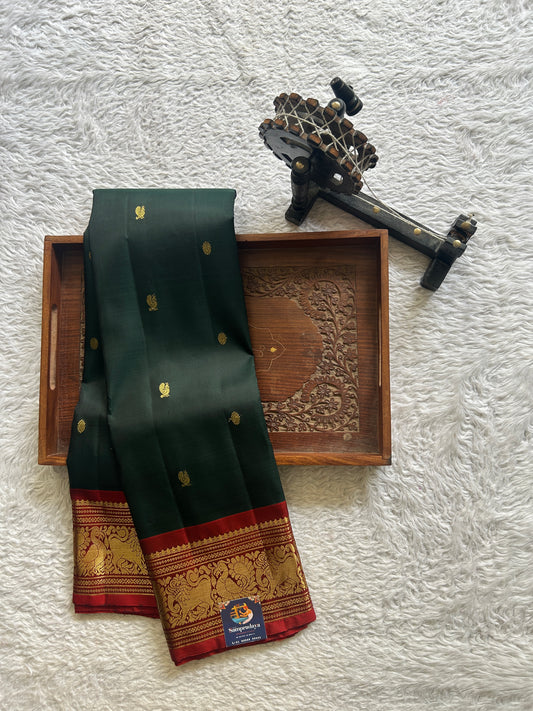 Pure Kanjivaram Silk Saree Bottle Green Colored Complemented with Maroon Color Border with a Gold Zari Weaving. - Sampradaya Designer Studio