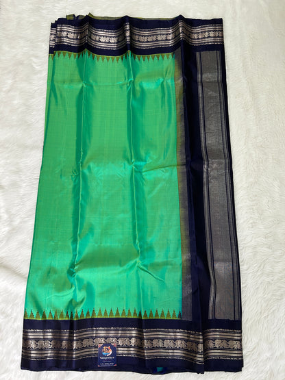 Gadwal Pattu Saree Green Colored Complemented With a Navy Blue Gap Border - Sampradaya Designer Studio