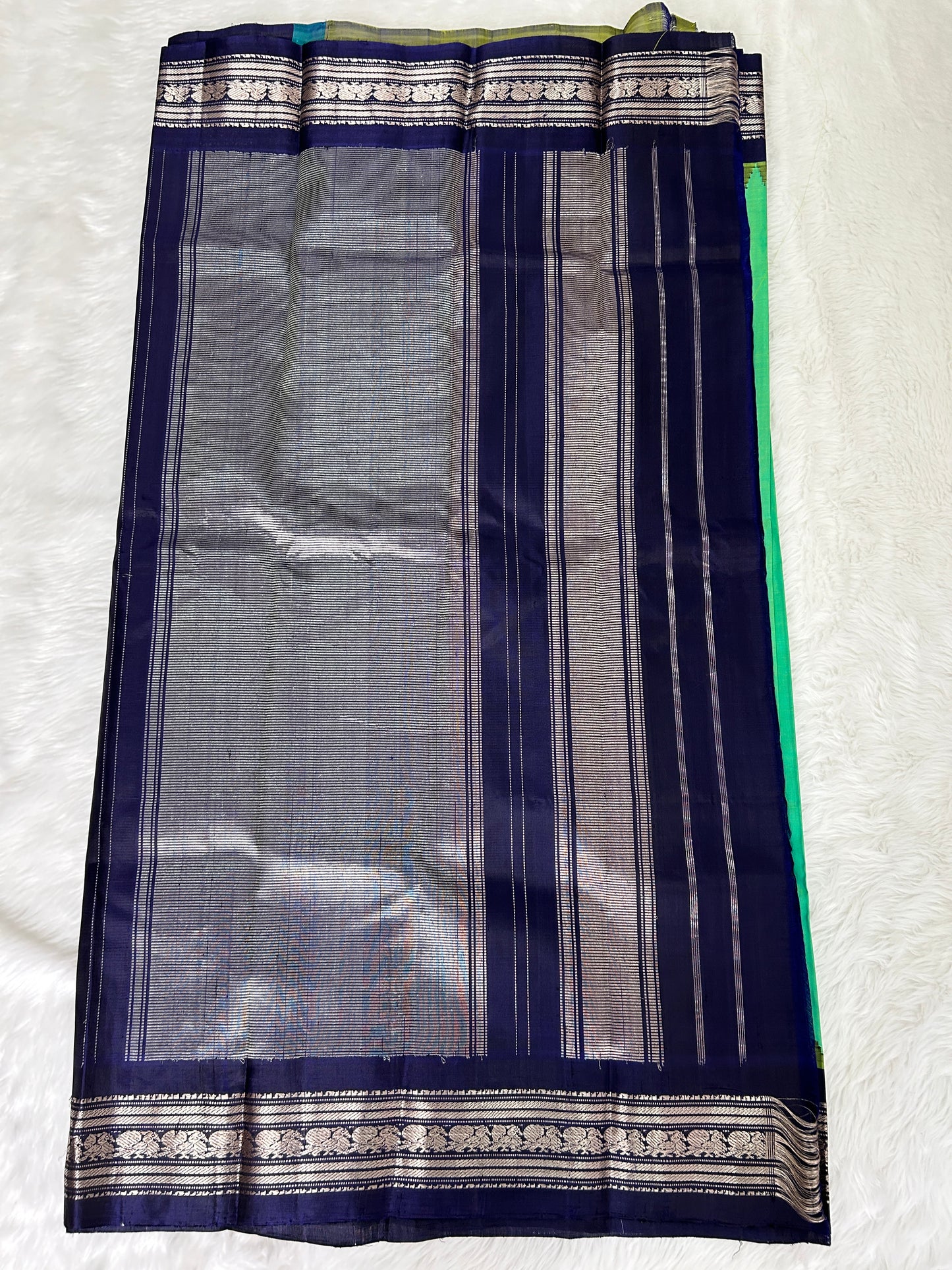 Gadwal Pattu Saree Green Colored Complemented With a Navy Blue Gap Border - Sampradaya Designer Studio