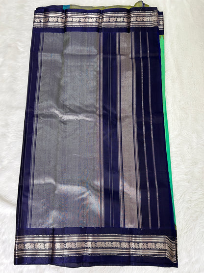 Gadwal Pattu Saree Green Colored Complemented With a Navy Blue Gap Border - Sampradaya Designer Studio