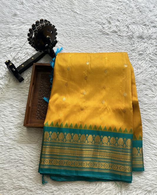 Gadwal Silk Saree Yellow Colored Complemented With a Sea Blue Color Zari Border - Sampradaya Designer Studio