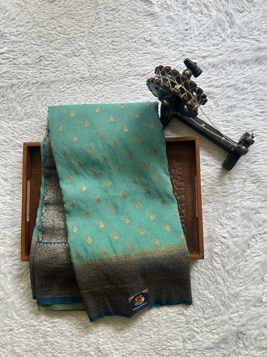 Semi Georgette Saree Sea Blue Colored Elegantly Paired with a Zari Border. - Sampradaya Designer Studio