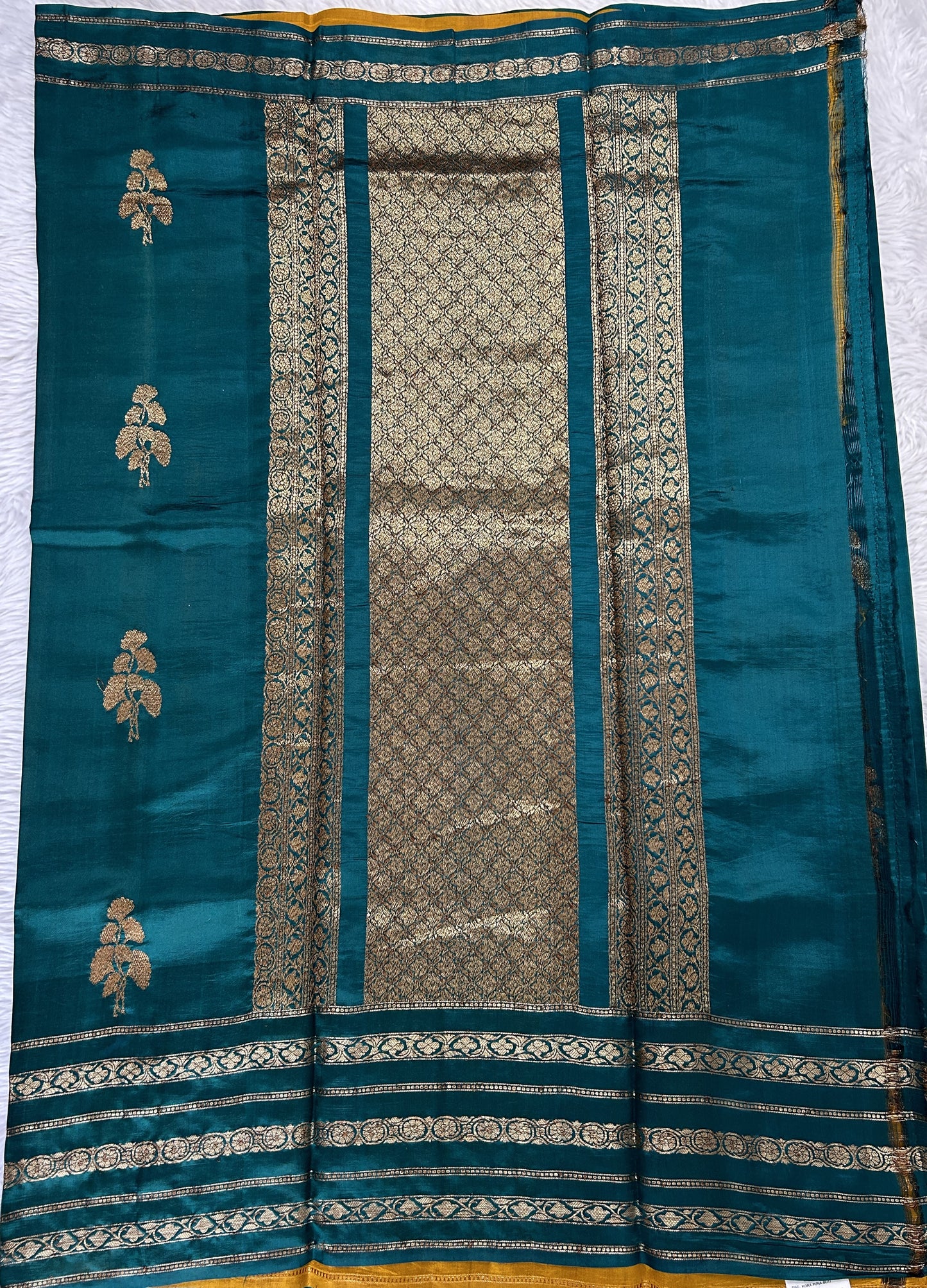 Raw Mango or Pooniya Silk Saree Bottle Green Colored Complemented With a Gap Border - Sampradaya Designer Studio