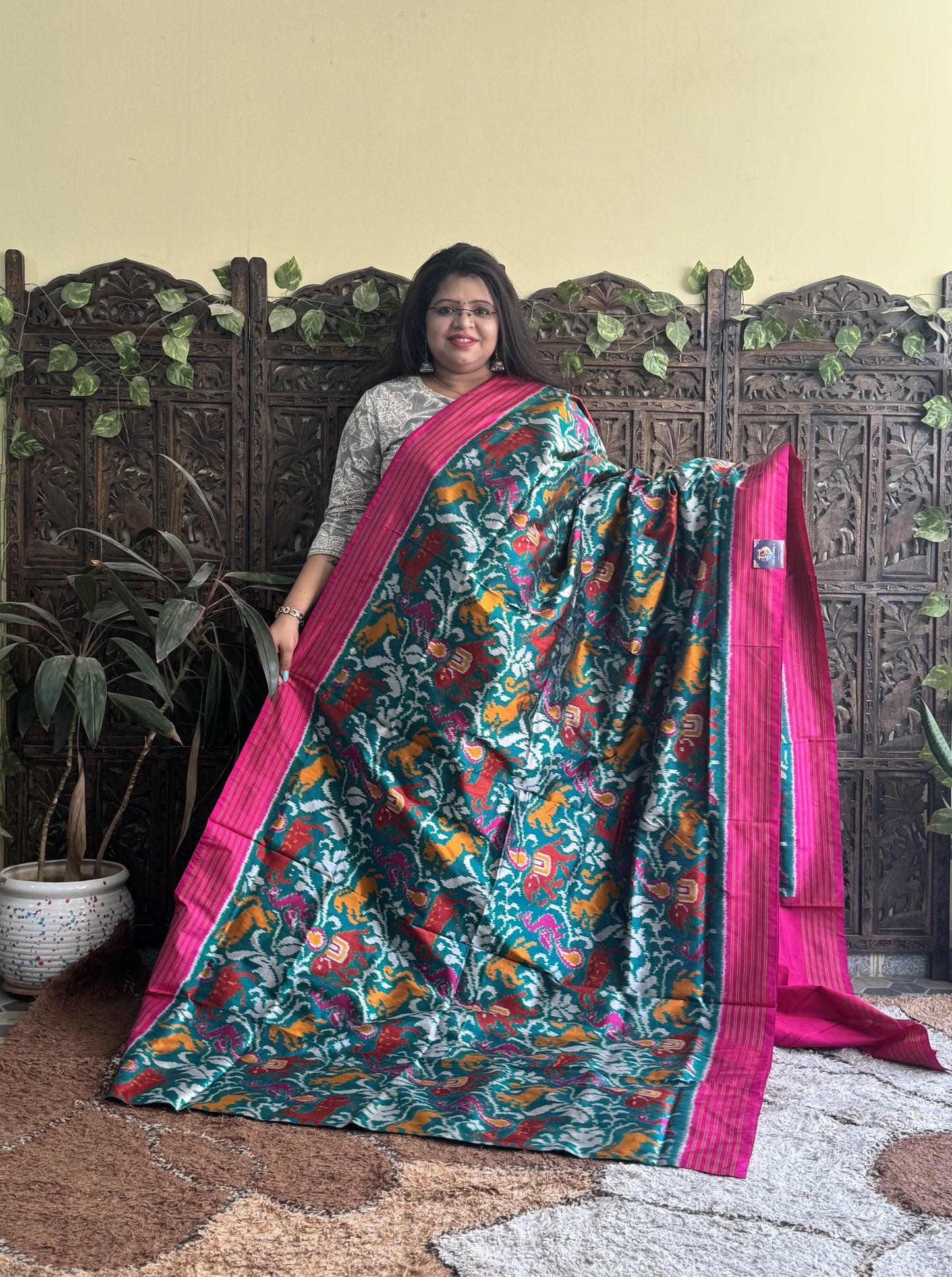 Ikkat Pattu Saree Green colored complemented with a Pink Patolla border. - Sampradaya Designer Studio