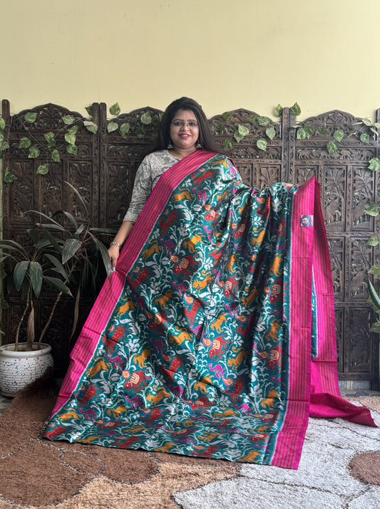 Ikkat Pattu Saree Green colored complemented with a Pink Patolla border. - Sampradaya Designer Studio