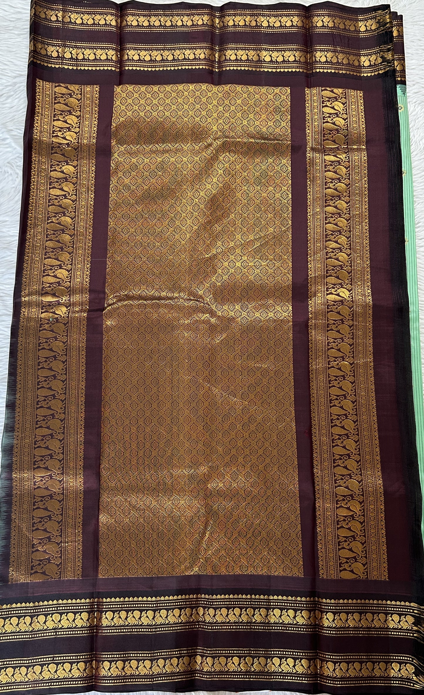 Gadwal Silk Saree Pastel Green colored complemented with a Brown Color Kanchi Gap Border - Sampradaya Designer Studio