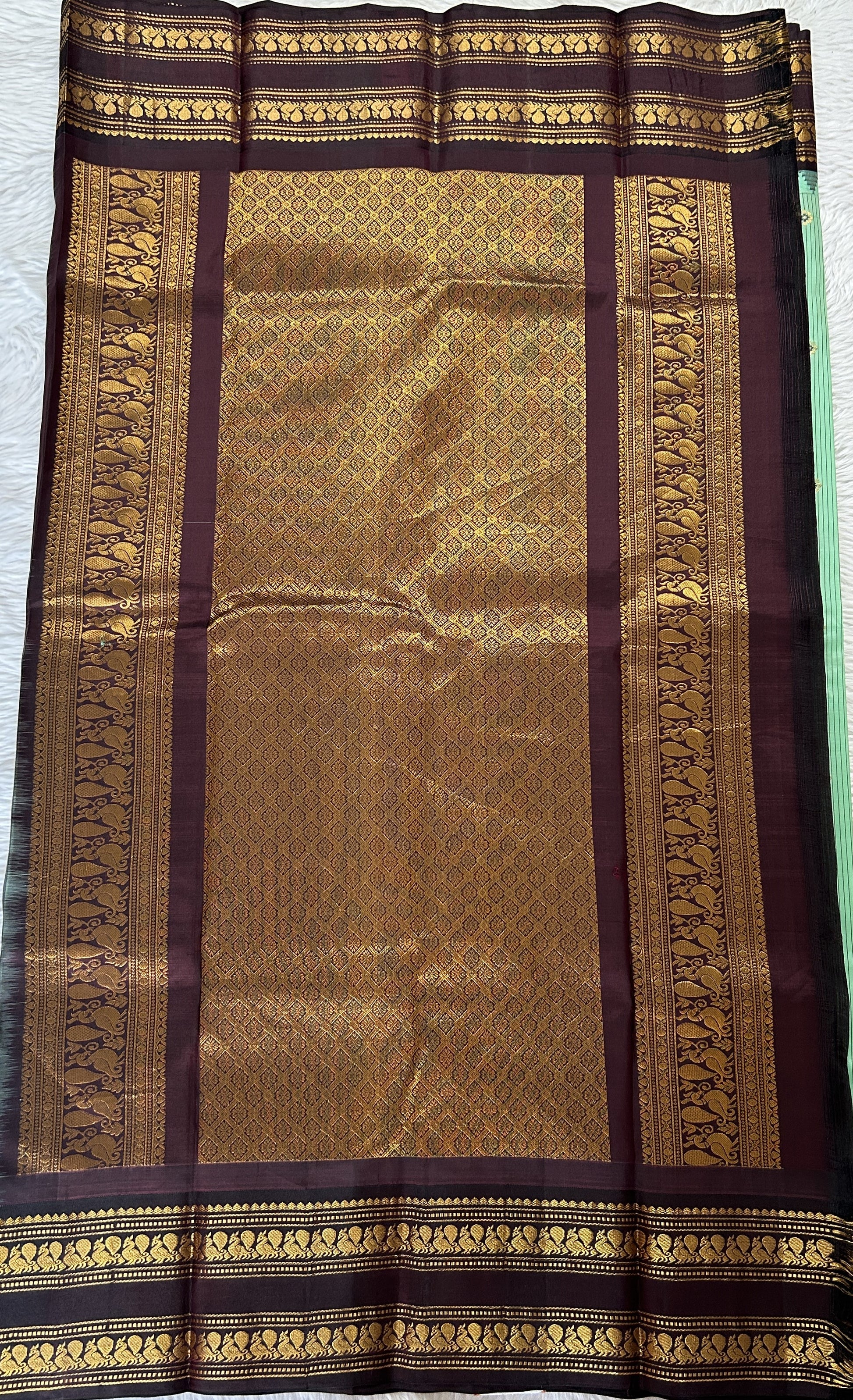 Gadwal Silk Saree Pastel Green colored complemented with a Brown Color Kanchi Gap Border - Sampradaya Designer Studio