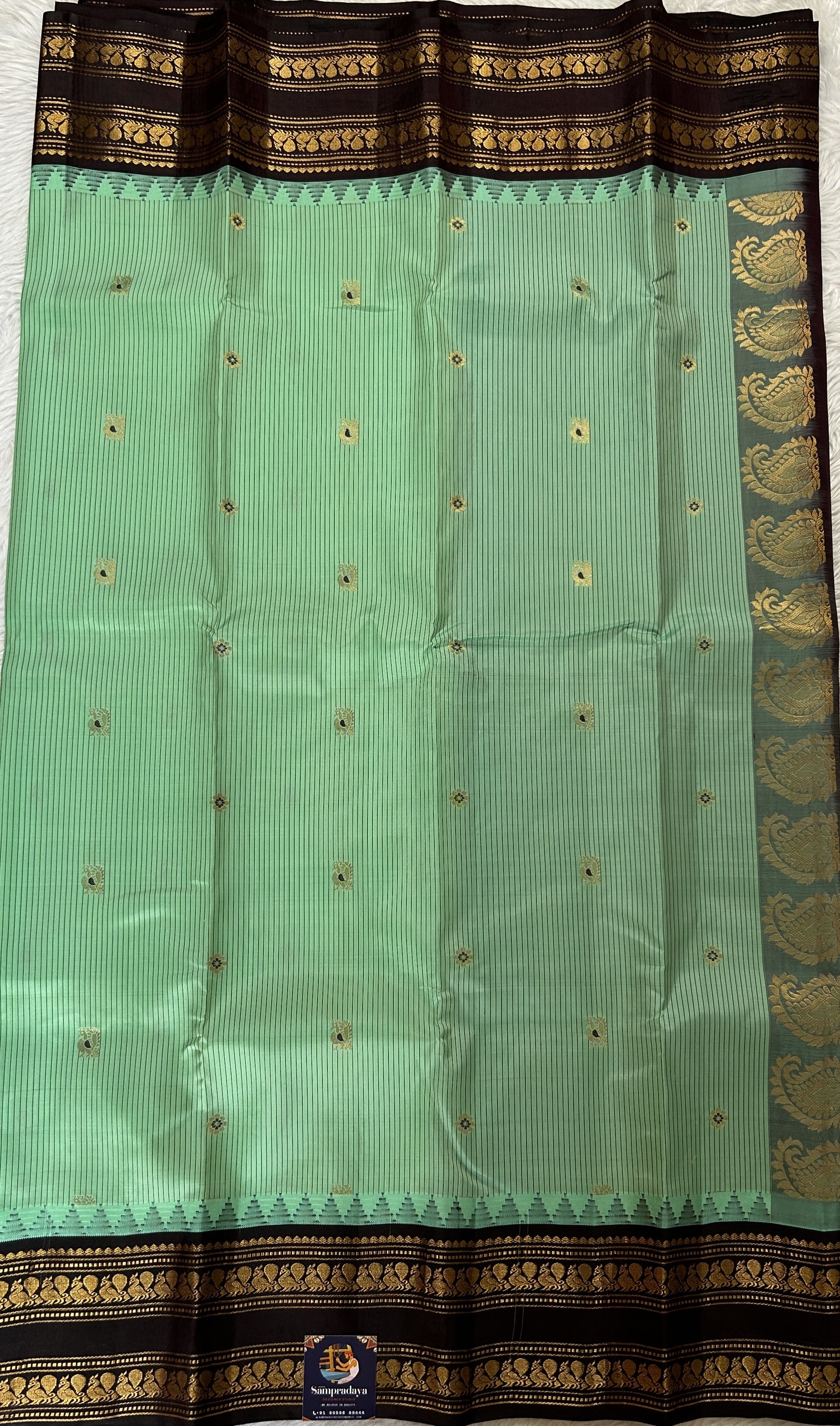 Gadwal Silk Saree Pastel Green colored complemented with a Brown Color Kanchi Gap Border - Sampradaya Designer Studio