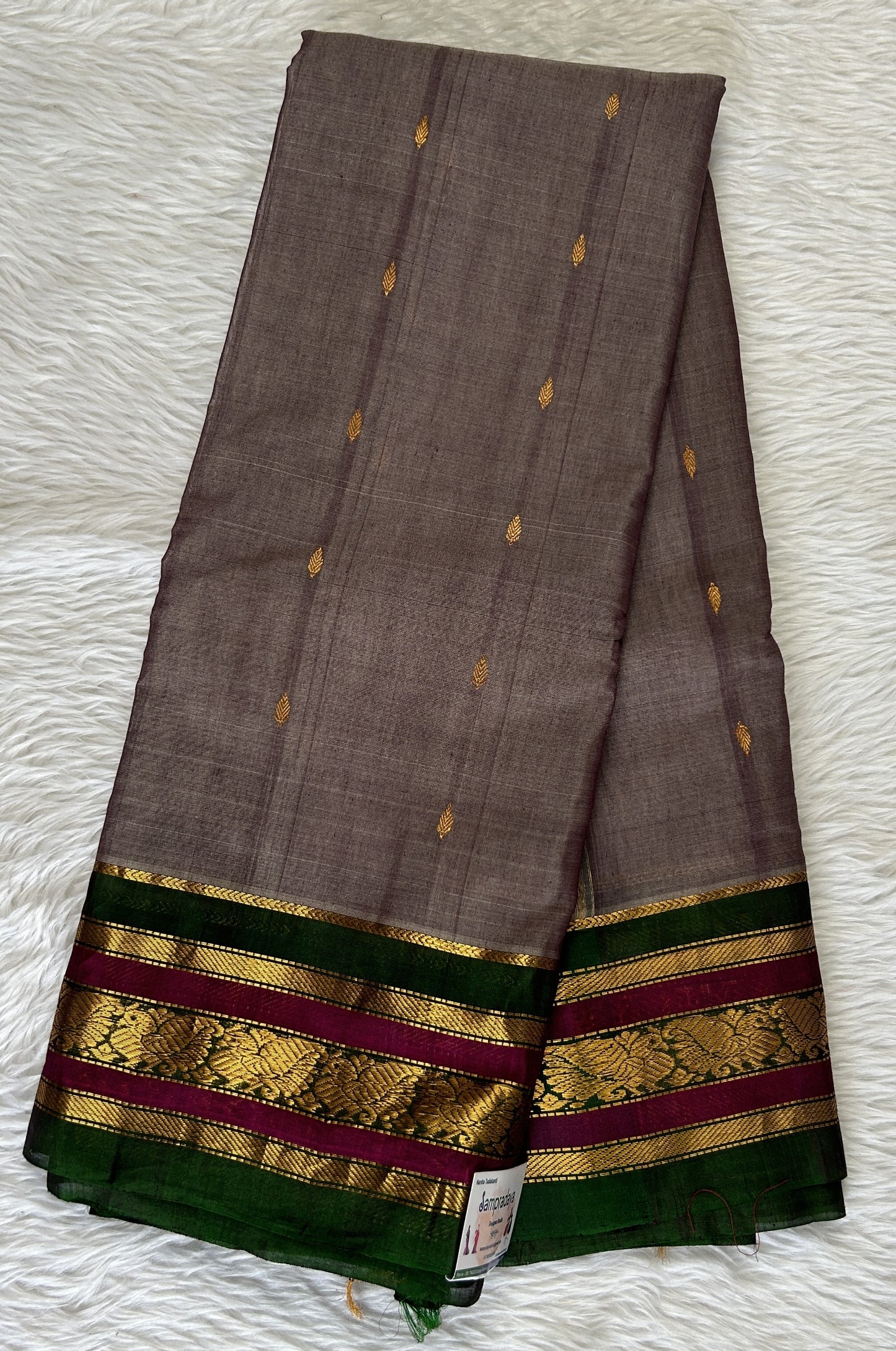 Gadwal Sico Saree Gray colored complemented with a Green Kanchi Gap Border. - Sampradaya Designer Studio
