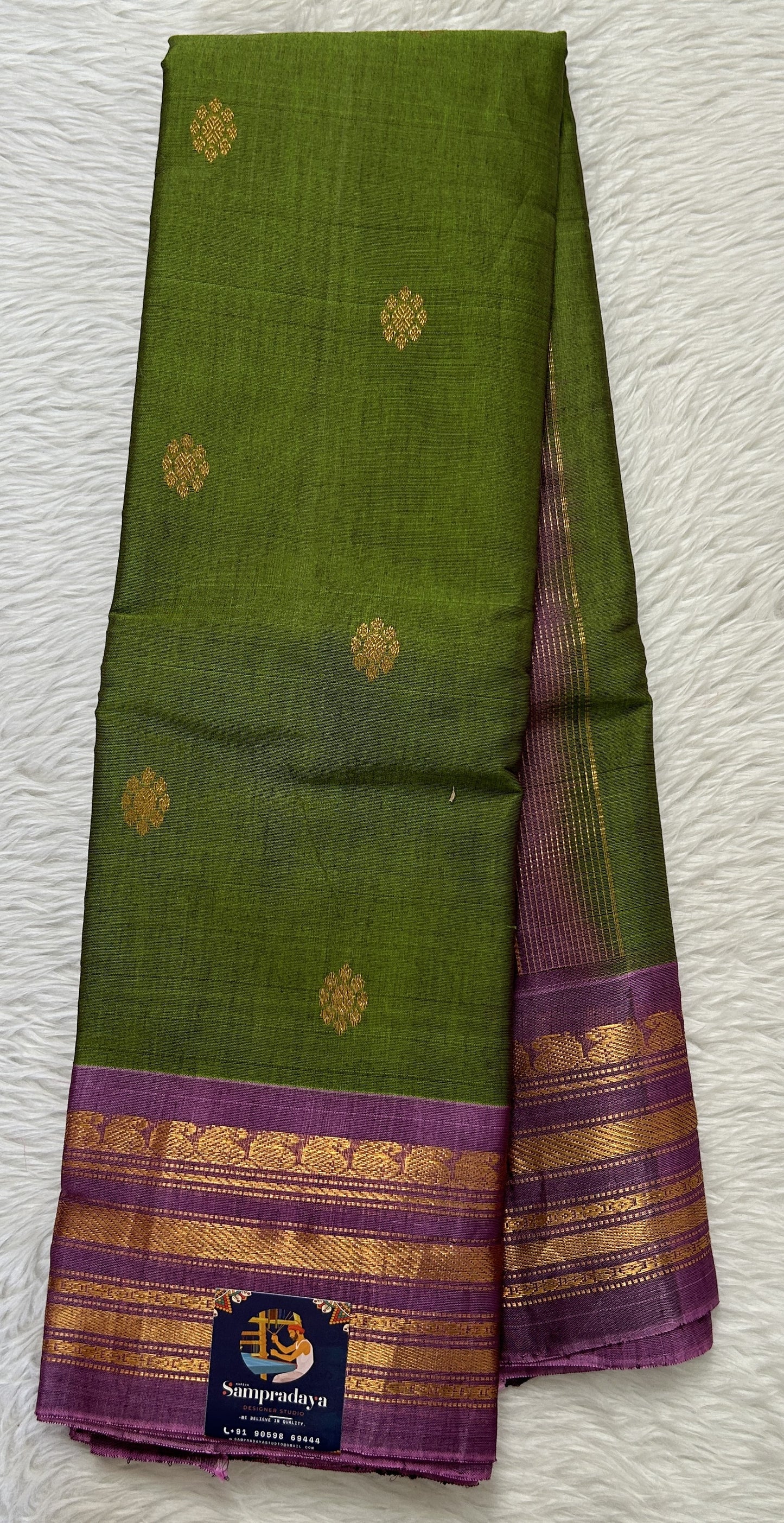 Gadwal Sico Saree Green colored complemented with a Lavender Kanchi Border. - Sampradaya Designer Studio