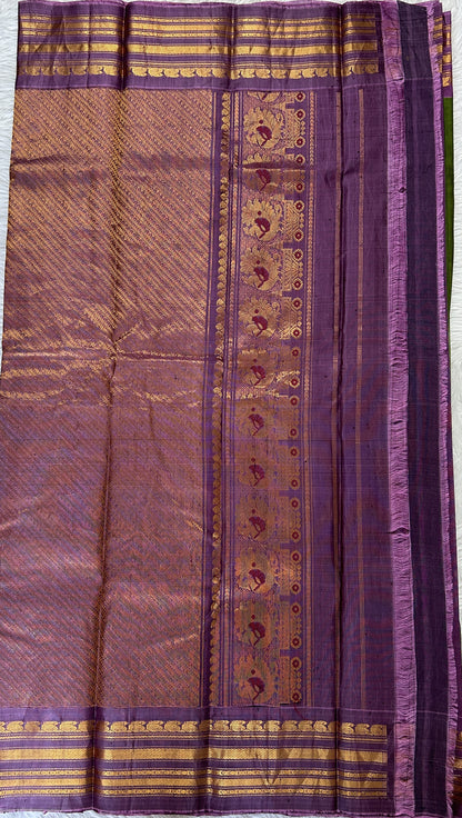 Gadwal Sico Saree Green colored complemented with a Lavender Kanchi Border. - Sampradaya Designer Studio