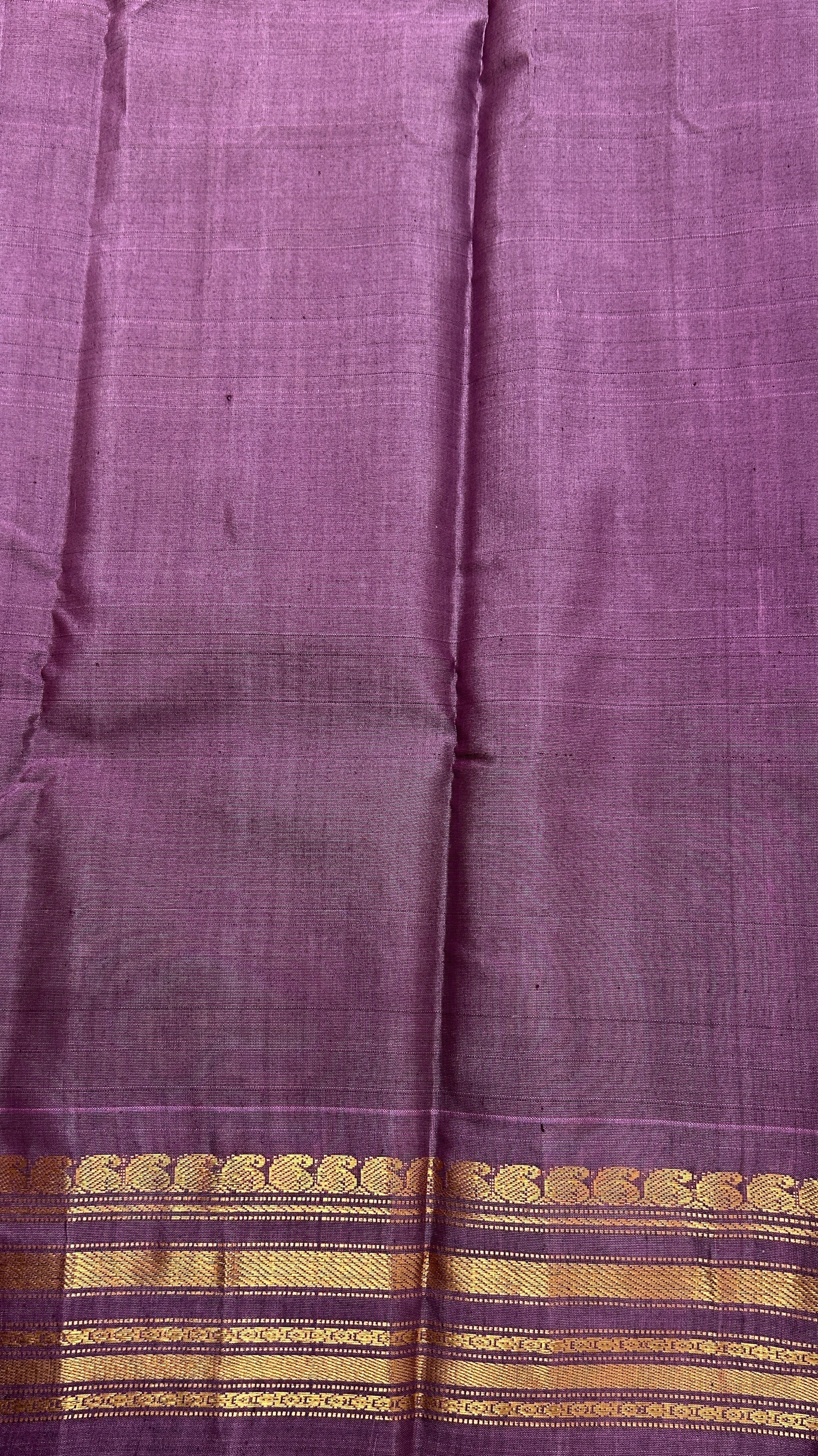 Gadwal Sico Saree Green colored complemented with a Lavender Kanchi Border. - Sampradaya Designer Studio