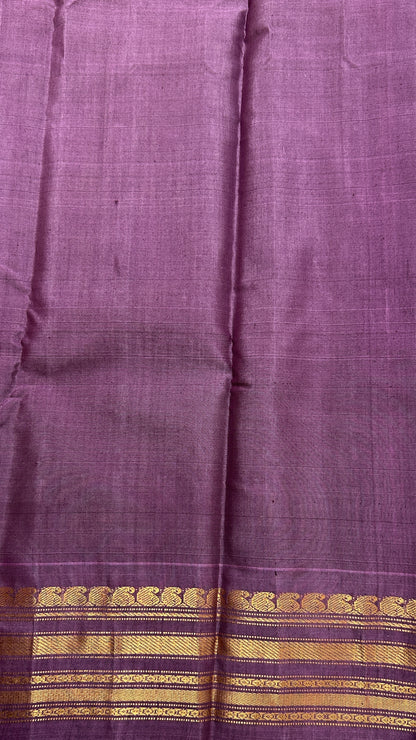 Gadwal Sico Saree Green colored complemented with a Lavender Kanchi Border. - Sampradaya Designer Studio