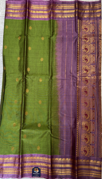 Gadwal Sico Saree Green colored complemented with a Lavender Kanchi Border. - Sampradaya Designer Studio