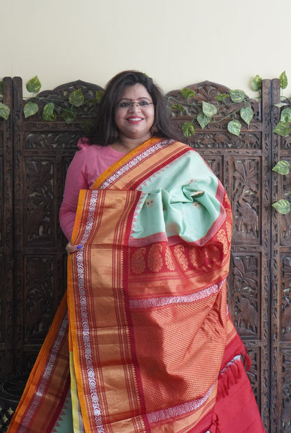 Gadwal Silk Saree Light Green Colored Complemented With a Red Zari Border - Sampradaya Designer Studio
