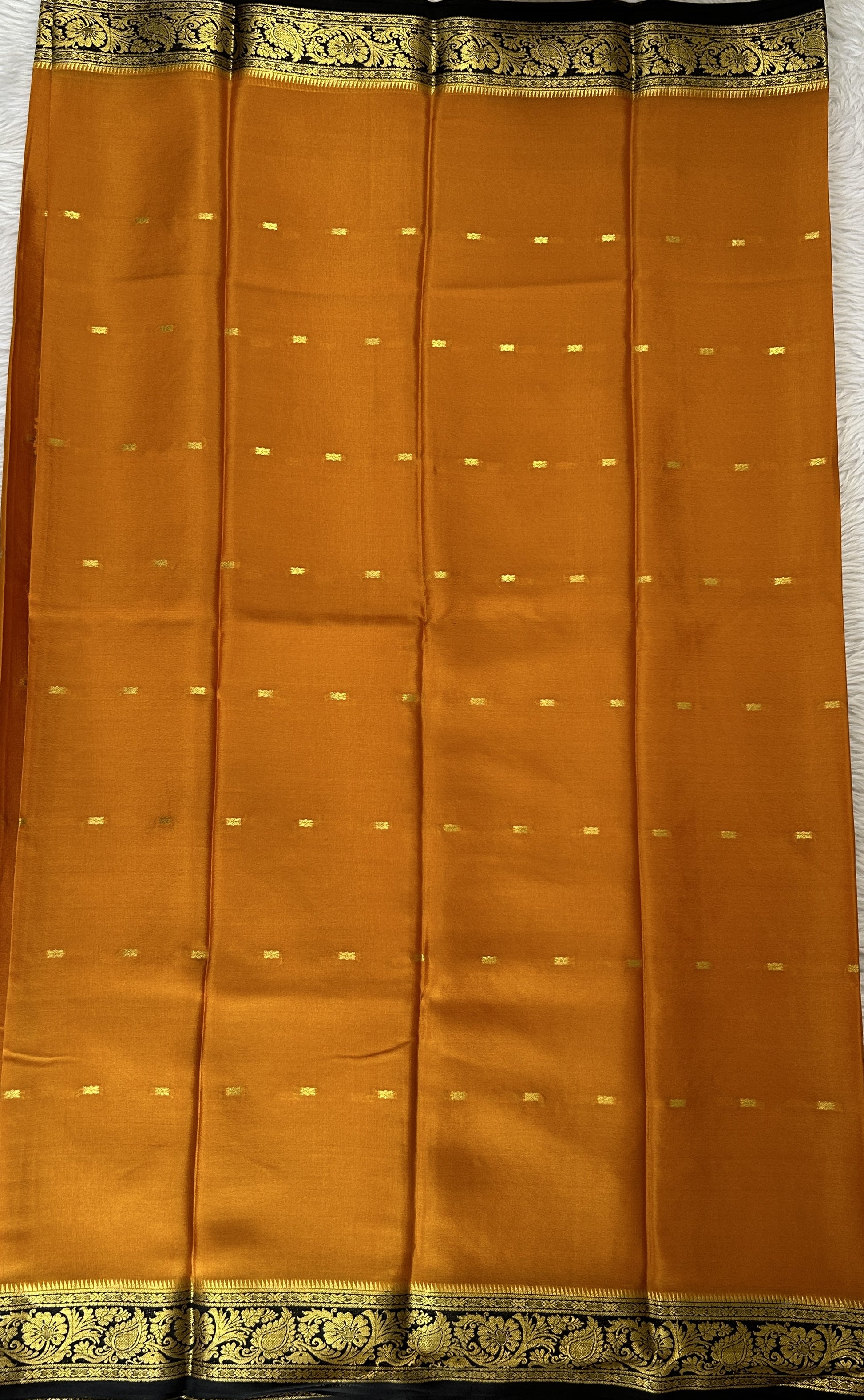 Mysore Crepe Silk Saree Orange Colored Complemented with a Black Zari Border. - Sampradaya Designer Studio