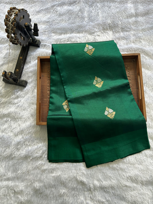 Pure Chiniya Silk Saree Bottle Green Colored Elegantly Paired with a Gold Zari Border.