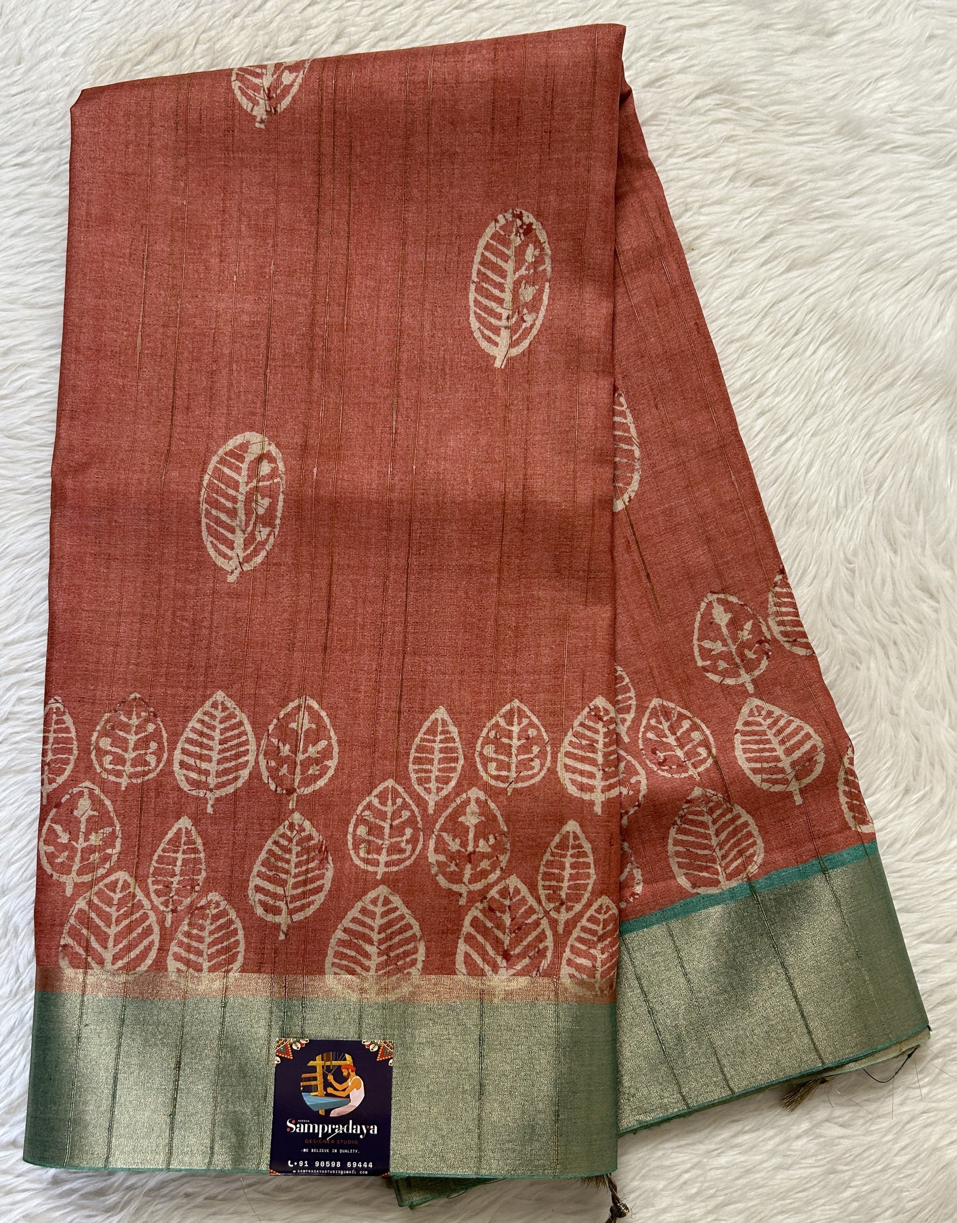 Semi Tussar Saree Rust Color Complemented with a Sea Blue Zari Border. - Sampradaya Designer Studio