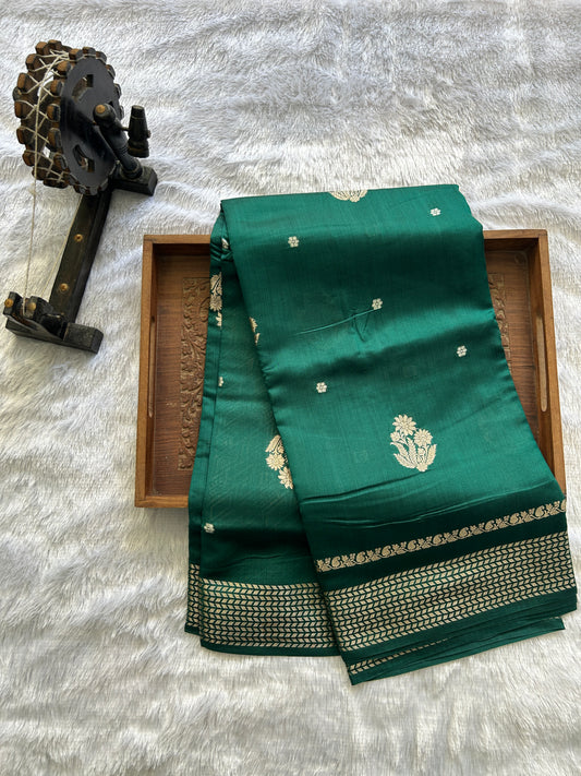 Pure Chiniya Silk Saree Bottle Green Colored Elegantly Paired with a Gold Zari Border.