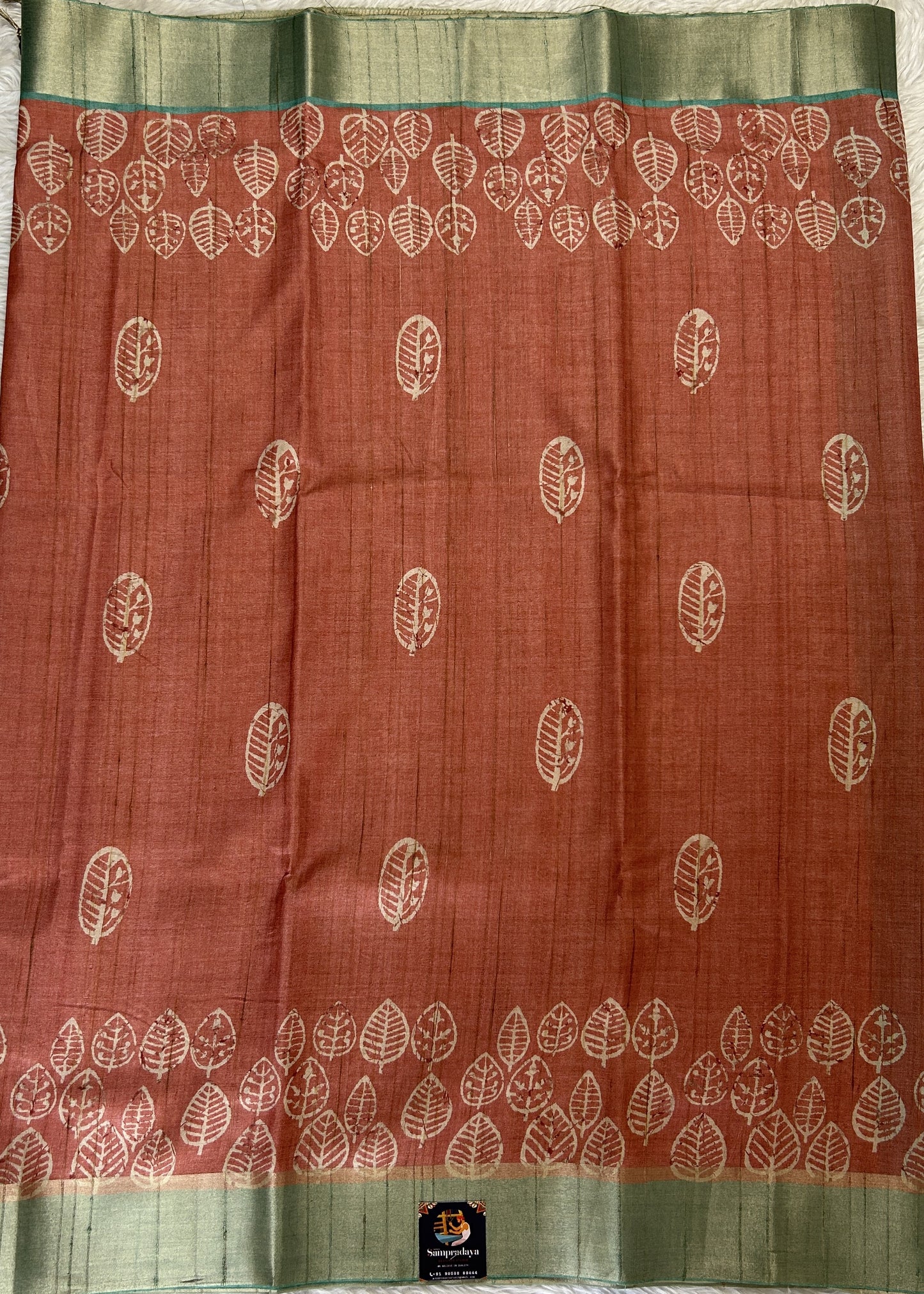 Semi Tussar Saree Rust Color Complemented with a Sea Blue Zari Border. - Sampradaya Designer Studio