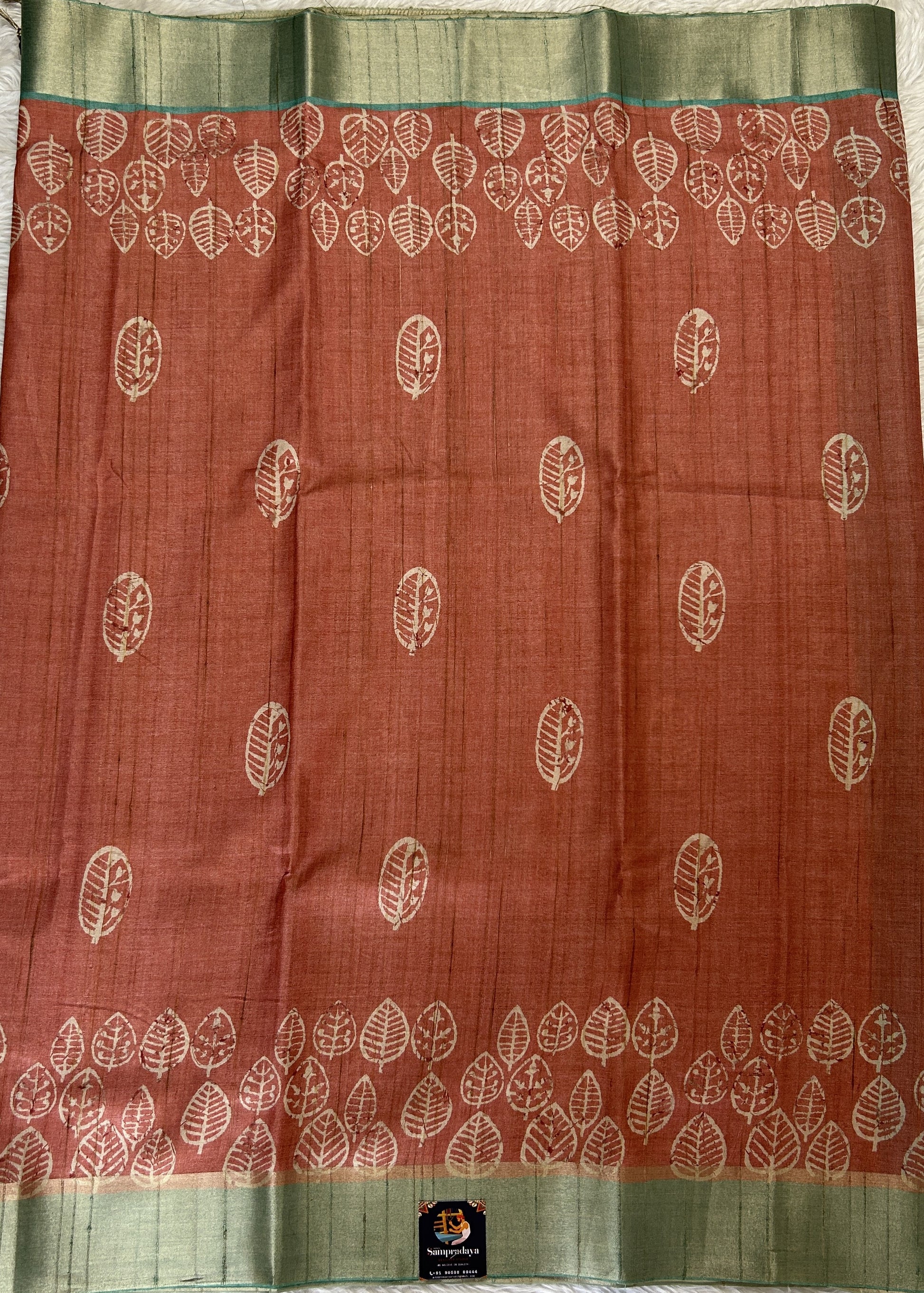 Semi Tussar Saree Rust Color Complemented with a Sea Blue Zari Border. - Sampradaya Designer Studio