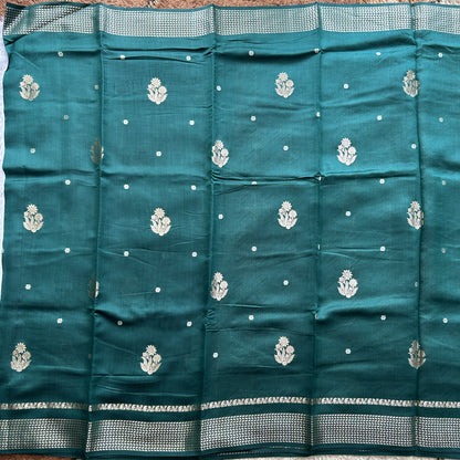 Pure Chiniya Silk Saree Bottle Green Colored Elegantly Paired with a Gold Zari Border.