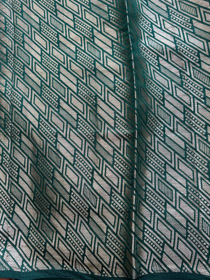 Pure Chiniya Silk Saree Bottle Green Colored Elegantly Paired with a Gold Zari Border.