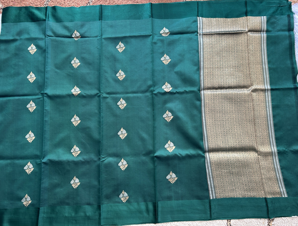 Pure Chiniya Silk Saree Bottle Green Colored Elegantly Paired with a Gold Zari Border.